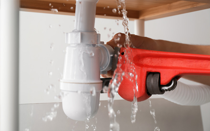 Image of someone trying to fix a leak