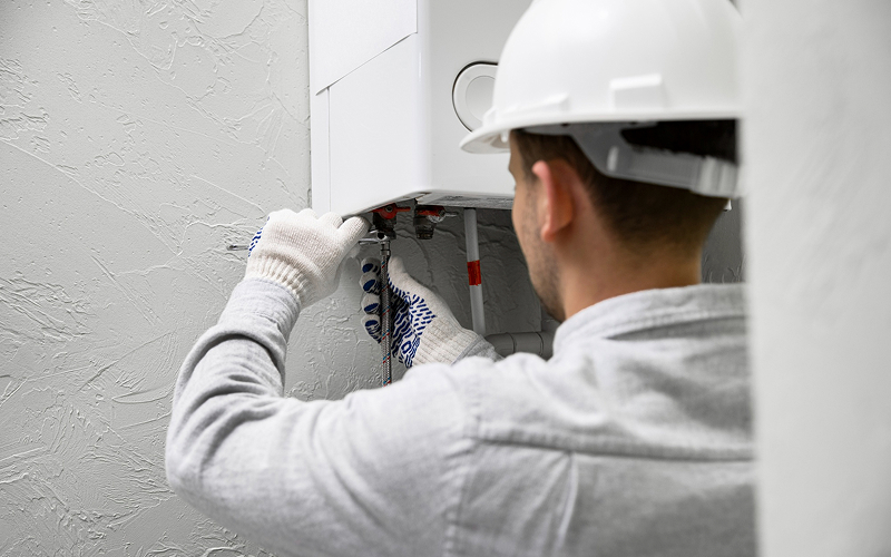 Plumber repairing a leaking water heater at a Singapore home.