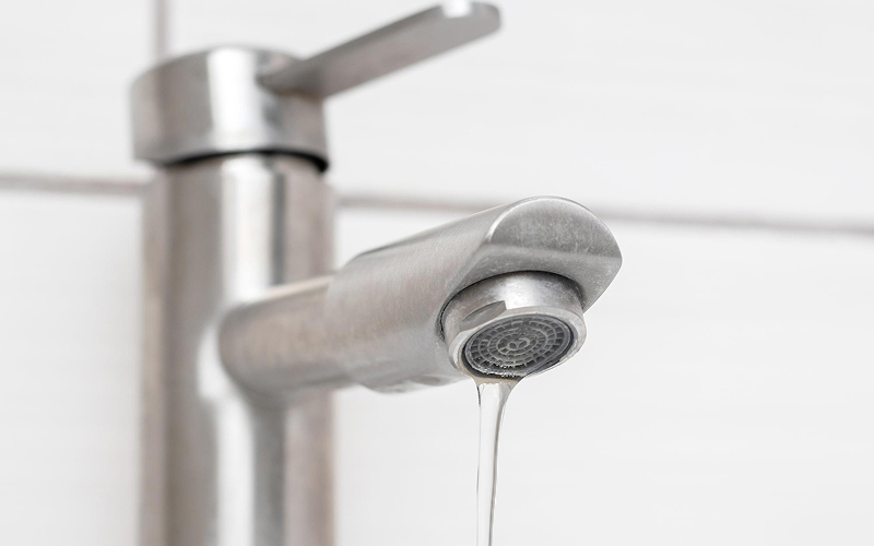Close-up of a kitchen faucet with low water flow.