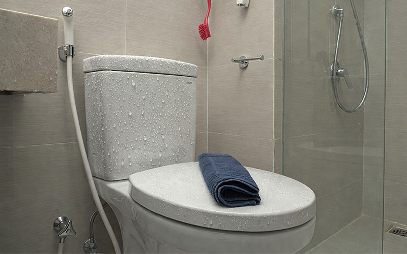 Modern bathroom with toilet and shower.