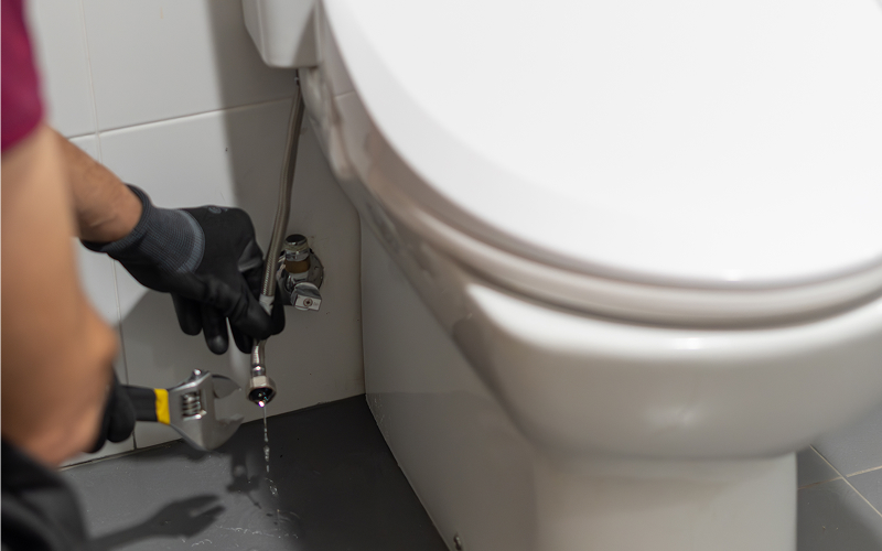 Plumber repairing a water leak.